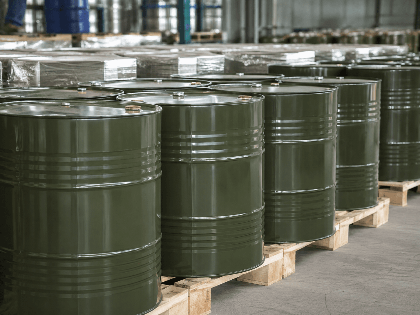 Steel drums stacked on pallets in a storage warehouse